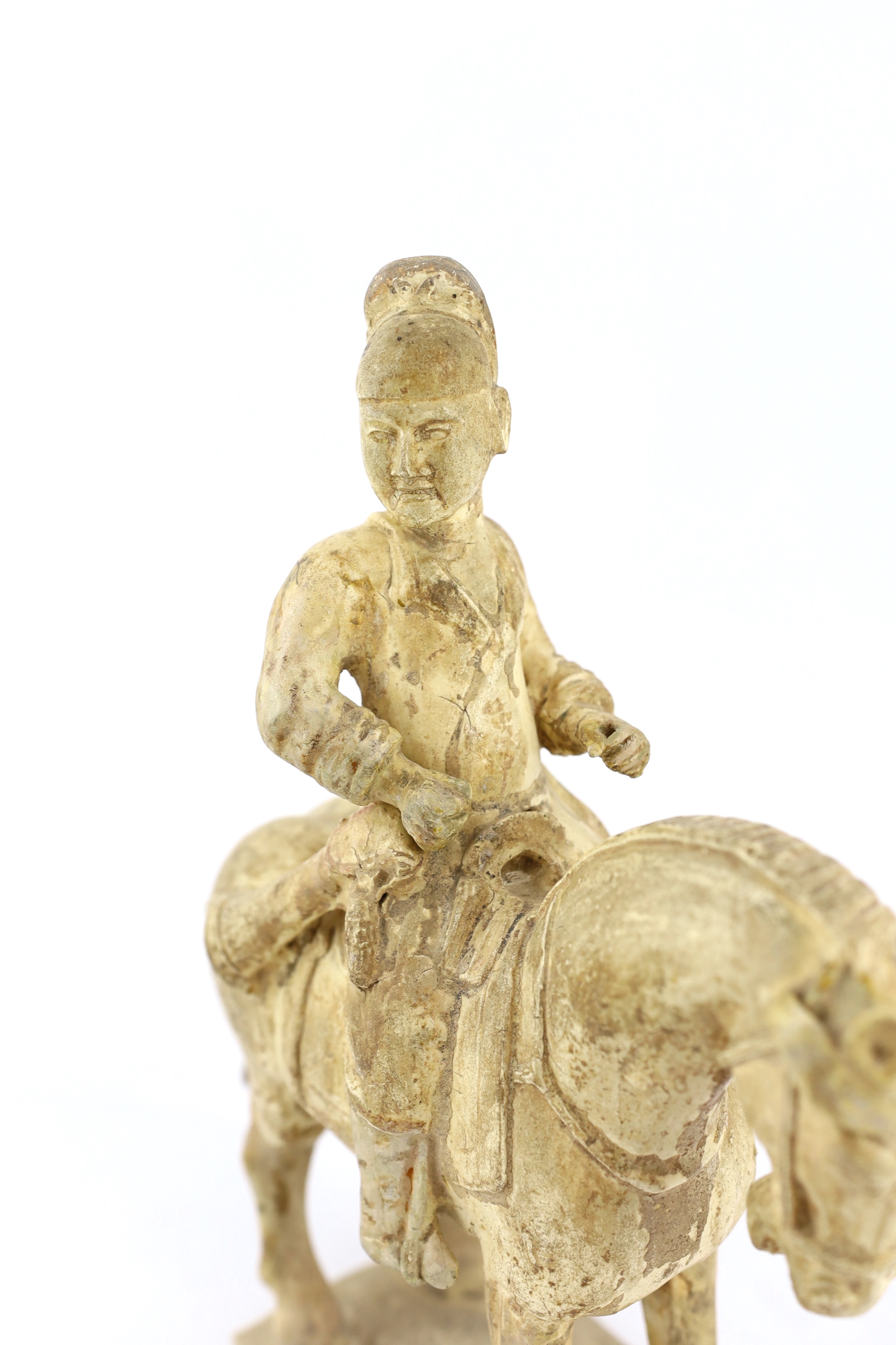 A Chinese cream glazed pottery model of an archer on horseback, Tang Dynasty (618-906 AD)